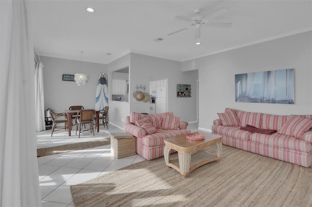 living room featuring ceiling fan, light tile floors, and ornamental molding