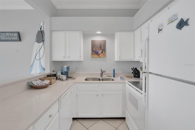 kitchen featuring sink, white appliances, white cabinetry, and light tile floors