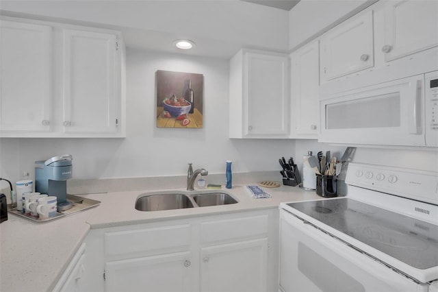 kitchen with white cabinets, stove, and sink