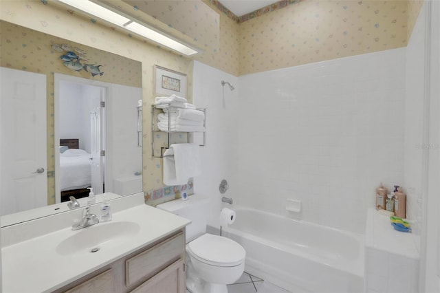 full bathroom with large vanity, tile floors, toilet, and shower / washtub combination