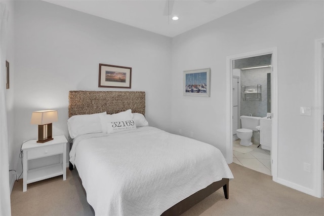 bedroom with connected bathroom, ceiling fan, and carpet floors