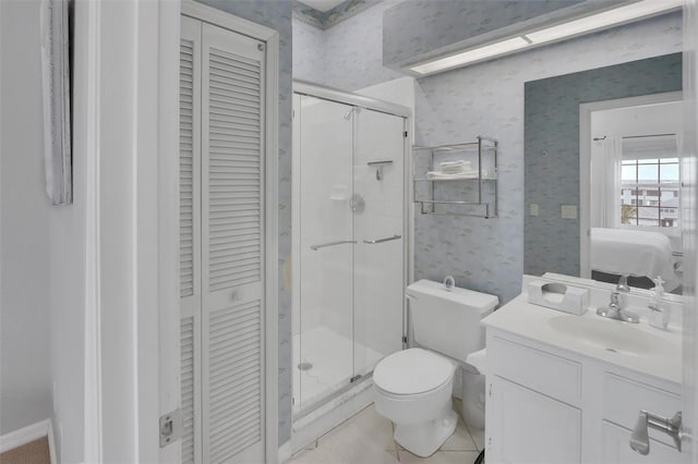 bathroom with tile floors, oversized vanity, toilet, and walk in shower