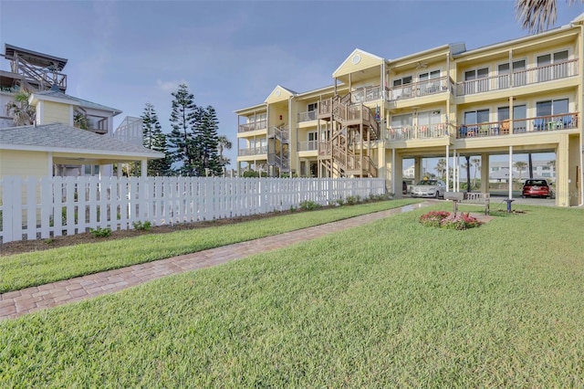 view of home's community featuring a lawn