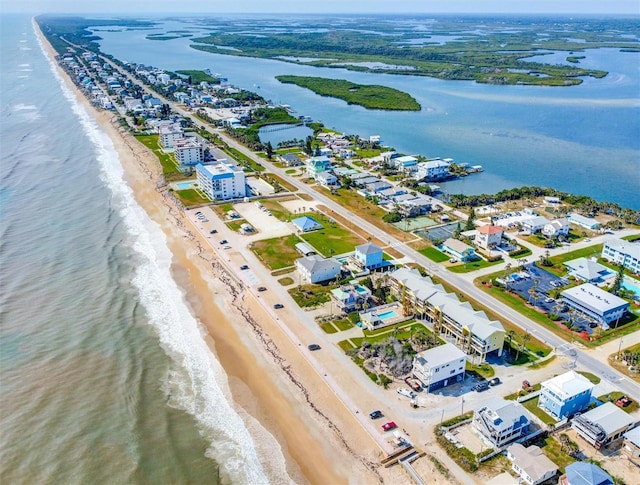 drone / aerial view with a water view and a view of the beach