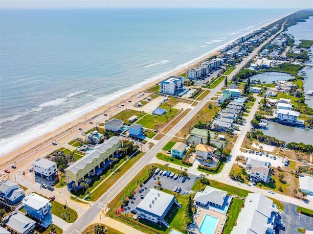 birds eye view of property with a beach view and a water view