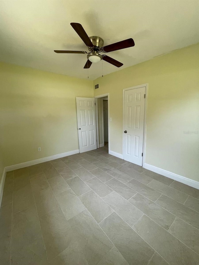 unfurnished bedroom with tile floors and ceiling fan