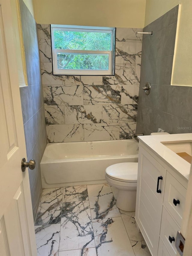 full bathroom featuring tiled shower / bath, vanity, toilet, and tile floors