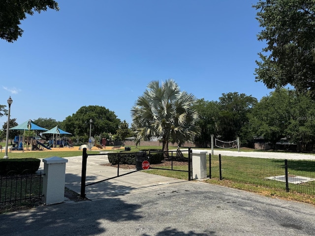 view of property's community with a playground and a lawn