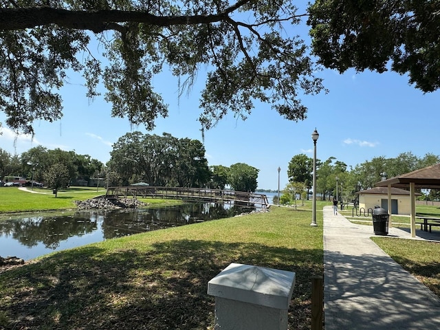 exterior space featuring a lawn and a water view