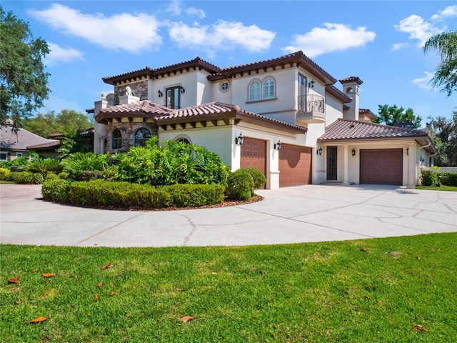 mediterranean / spanish-style home with a balcony, a garage, and a front yard