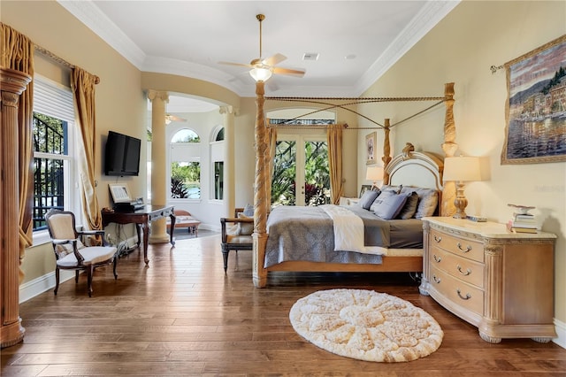 bedroom featuring ornamental molding, dark wood-type flooring, and decorative columns