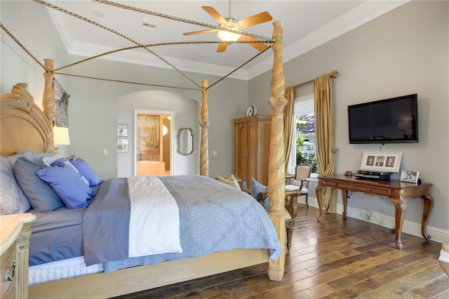 bedroom featuring crown molding, ensuite bath, ceiling fan, and hardwood / wood-style floors