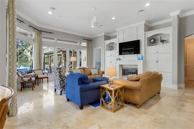 tiled living room with built in features, ornamental molding, and ceiling fan