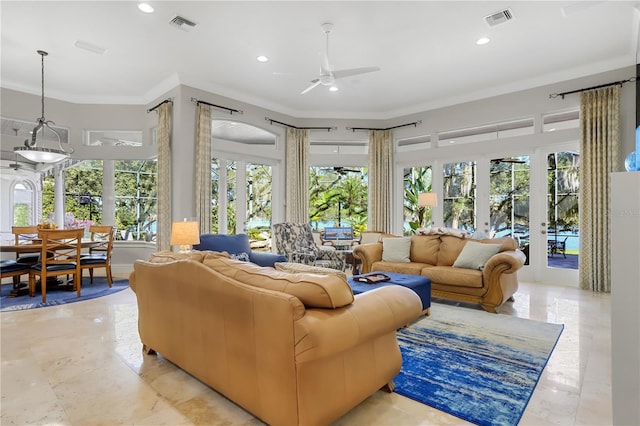 tiled living room featuring ornamental molding, ceiling fan, a healthy amount of sunlight, and french doors