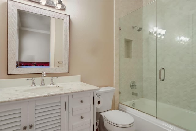 full bathroom featuring toilet, bath / shower combo with glass door, and vanity