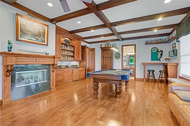 game room featuring pool table, light hardwood / wood-style floors, beam ceiling, coffered ceiling, and a fireplace