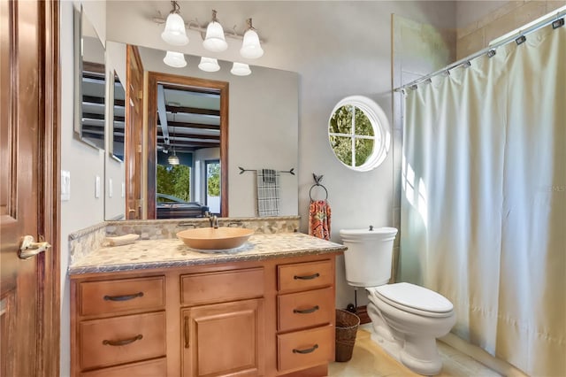 bathroom with vanity, toilet, and tile flooring