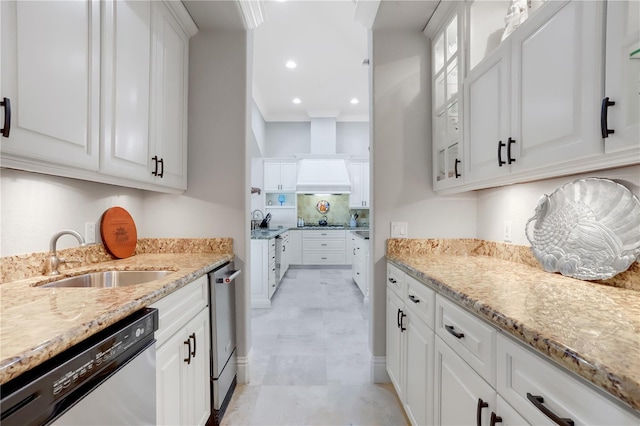 kitchen featuring light stone counters, light tile floors, white cabinets, dishwasher, and premium range hood