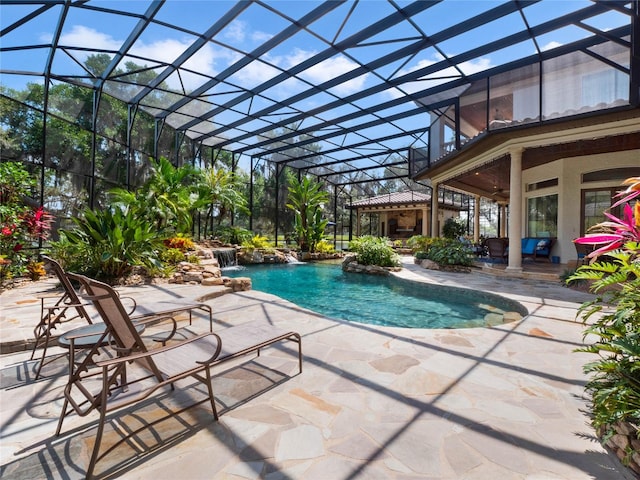 view of swimming pool featuring a lanai, pool water feature, and a patio area