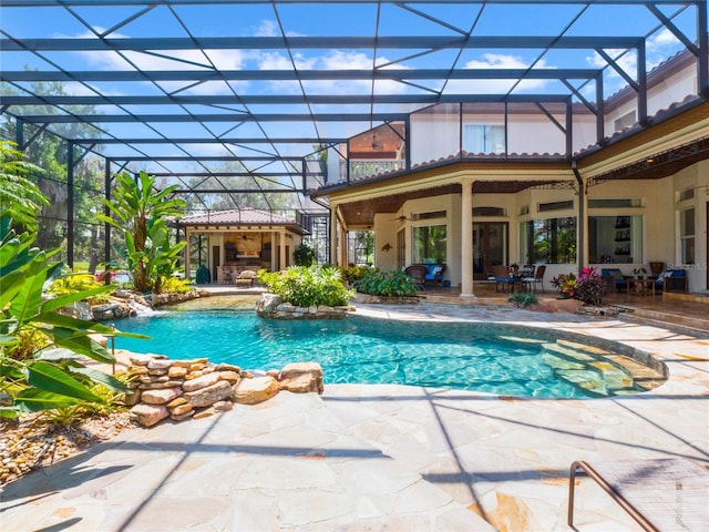 view of swimming pool with a lanai, pool water feature, and a patio area