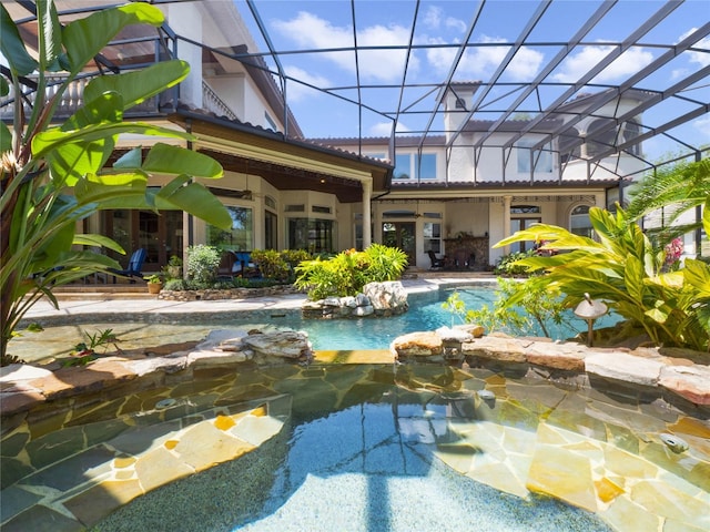 view of pool featuring french doors, a lanai, and a patio area