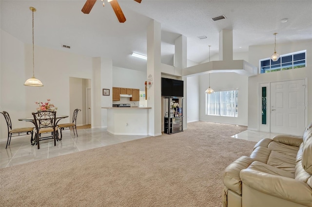 living room with light carpet, high vaulted ceiling, and ceiling fan