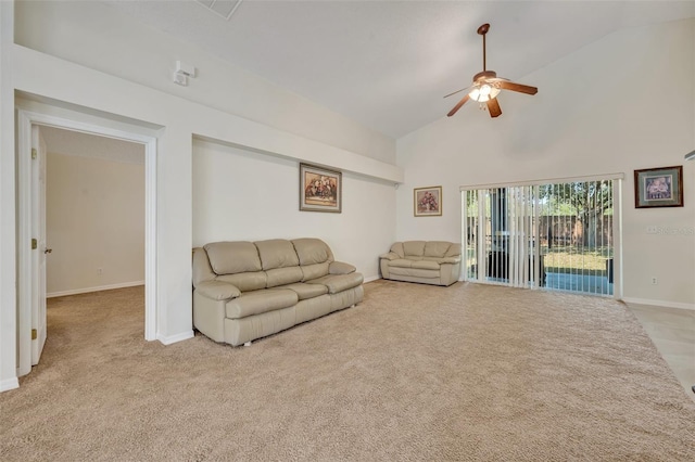 carpeted living room with ceiling fan and high vaulted ceiling