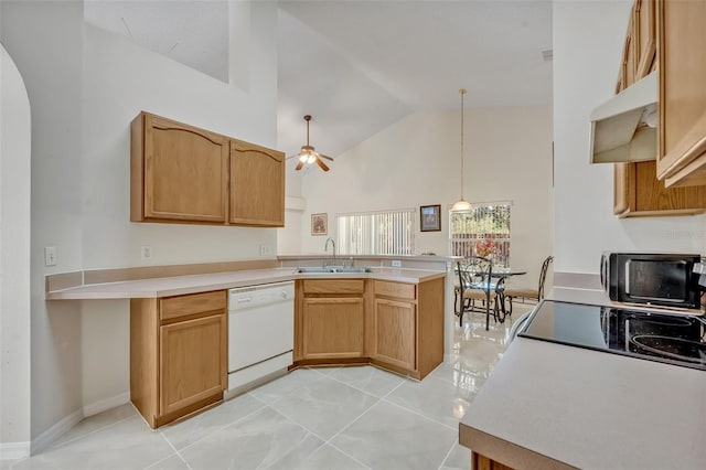 kitchen with sink, dishwasher, kitchen peninsula, hanging light fixtures, and high vaulted ceiling