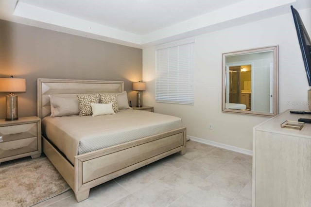 tiled bedroom featuring a raised ceiling