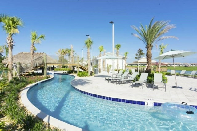 view of swimming pool featuring a patio area