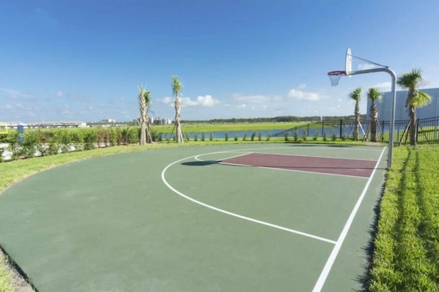 view of sport court with a water view