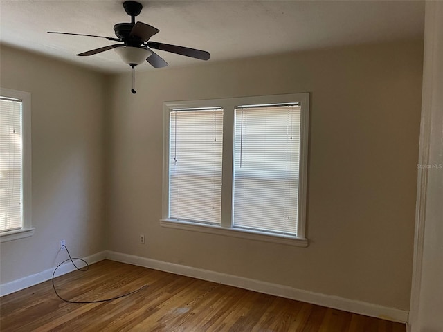 unfurnished room with ceiling fan and hardwood / wood-style floors