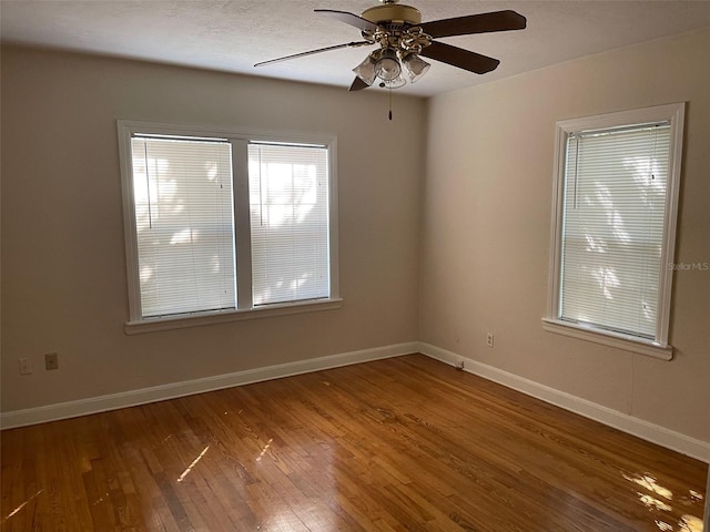 empty room featuring wood-type flooring and ceiling fan