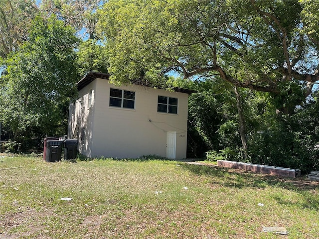 view of home's exterior with a lawn