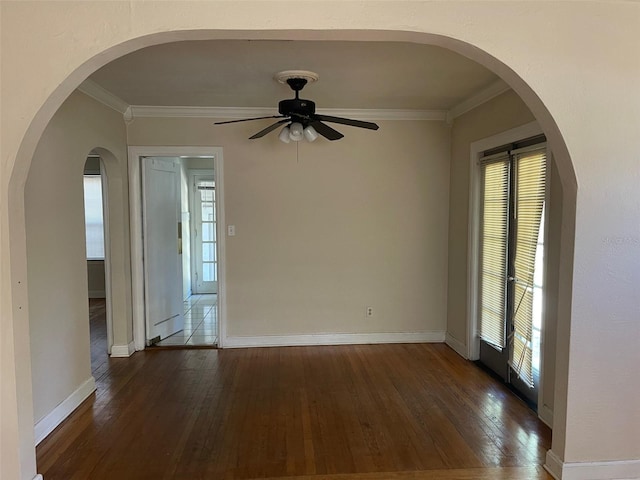 unfurnished room featuring ornamental molding, ceiling fan, and dark wood-type flooring