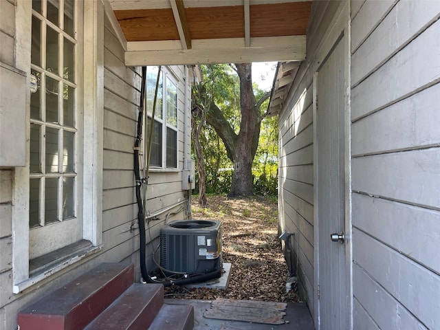 view of side of home featuring central AC