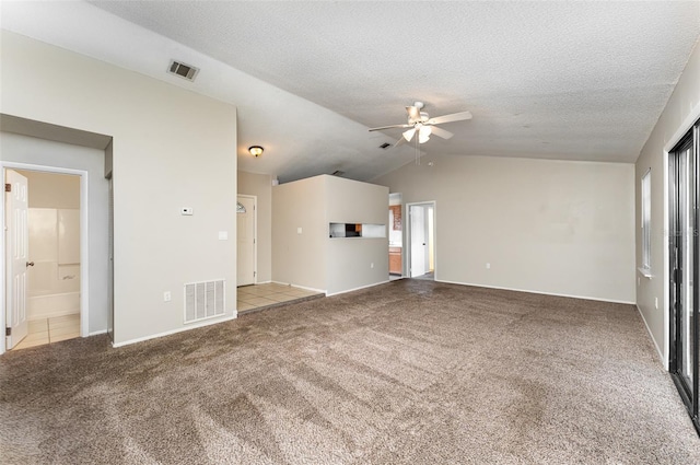 unfurnished living room featuring vaulted ceiling, light carpet, ceiling fan, and a textured ceiling