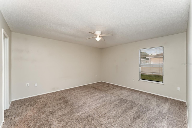 carpeted spare room with ceiling fan and a textured ceiling