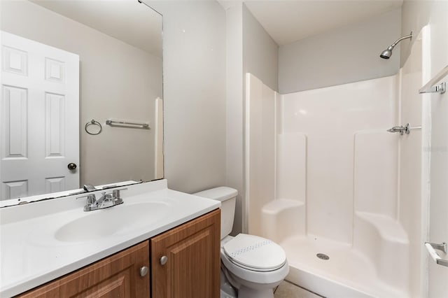 bathroom with a shower, toilet, and vanity