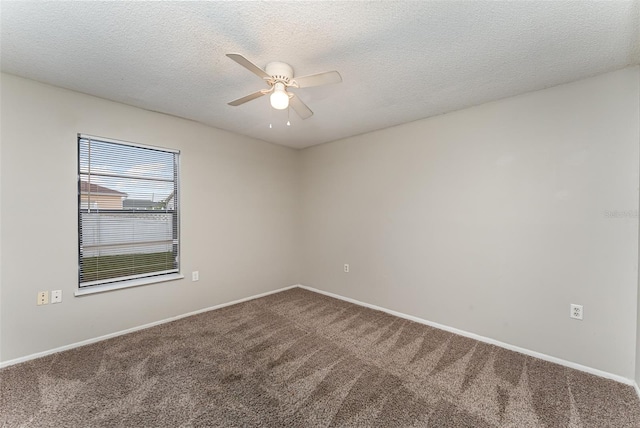 carpeted spare room featuring a textured ceiling and ceiling fan