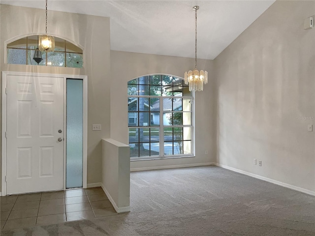 entrance foyer with lofted ceiling, a chandelier, and carpet flooring