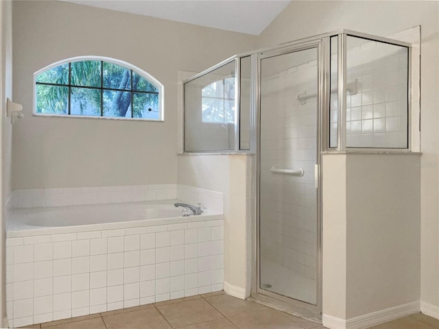 bathroom with tile floors, independent shower and bath, and lofted ceiling