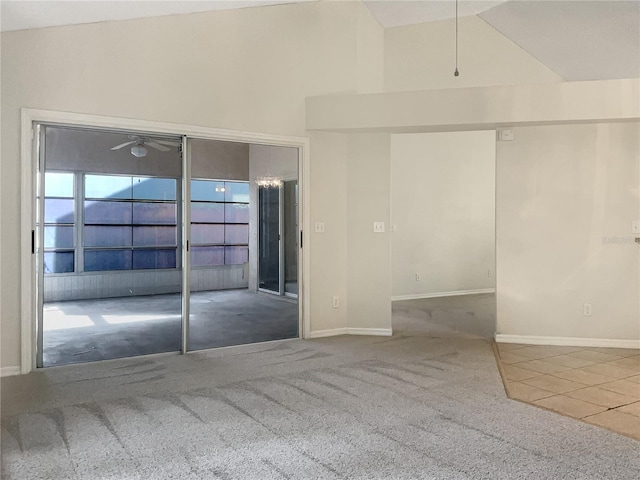 tiled empty room with high vaulted ceiling and ceiling fan