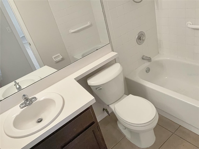 full bathroom with tile flooring, tiled shower / bath, vanity, and toilet