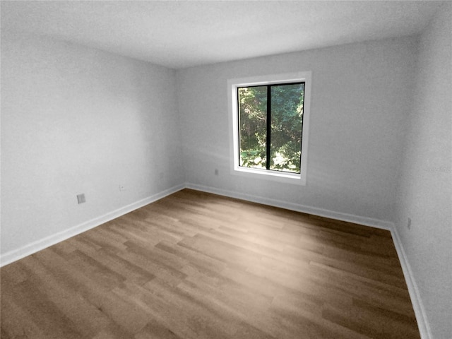 unfurnished room featuring hardwood / wood-style flooring