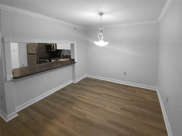 unfurnished dining area featuring dark hardwood / wood-style flooring, crown molding, and sink