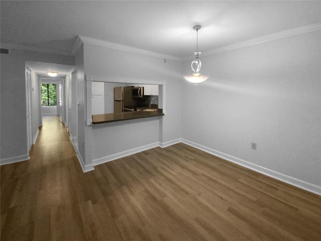 unfurnished room featuring sink, crown molding, and dark hardwood / wood-style floors