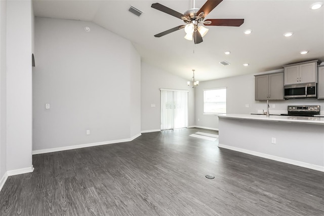 unfurnished living room with lofted ceiling, ceiling fan, and dark wood-type flooring