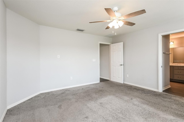 unfurnished bedroom with ceiling fan and dark colored carpet