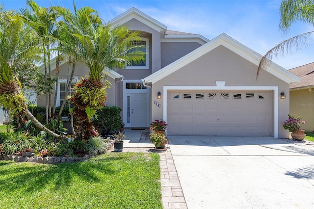 view of front of home featuring a garage and a front yard